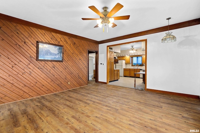 16905 E 1600th St, Bushnell, IL 61422 - unfurnished living room featuring wood walls, ceiling fan, and light wood-style floors