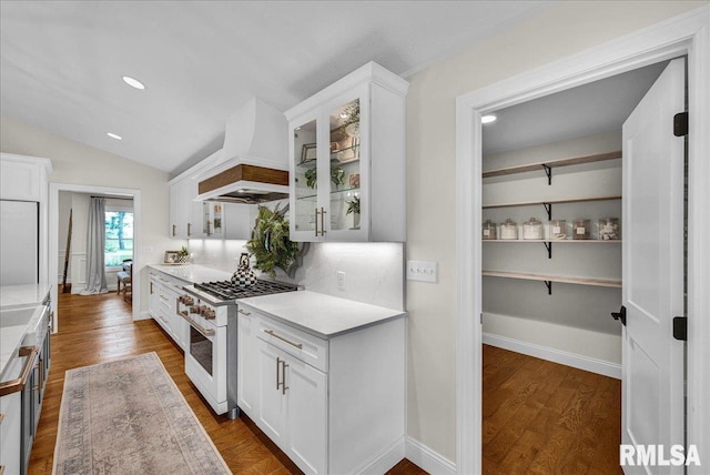 12804 W Dell Rd, Princeville, IL 61559 - kitchen featuring high end white range, custom range hood, white cabinetry, glass insert cabinets, and lofted ceiling