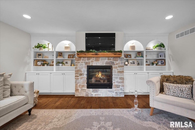 12804 W Dell Rd, Princeville, IL 61559 - living area featuring wood finished floors, a fireplace, built in features, and recessed lighting