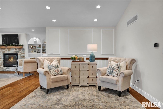 12804 W Dell Rd, Princeville, IL 61559 - sitting room featuring wood finished floors, a stone fireplace, and recessed lighting