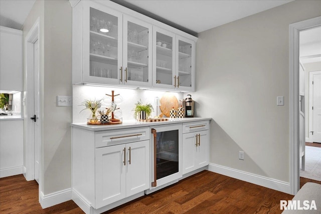 12804 W Dell Rd, Princeville, IL 61559 - indoor dry bar with beverage cooler, dark wood finished floors, and backsplash