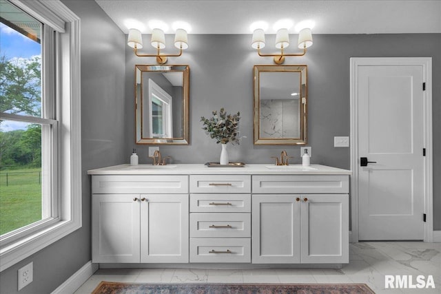 12804 W Dell Rd, Princeville, IL 61559 - bathroom with marble look tile flooring, double vanity, and plenty of natural light