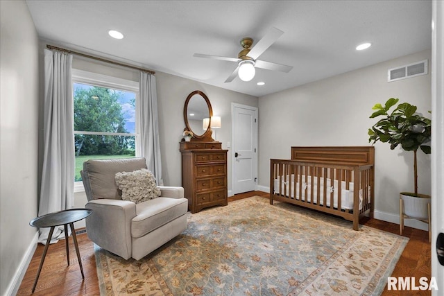 12804 W Dell Rd, Princeville, IL 61559 - bedroom featuring a nursery area, recessed lighting, wood finished floors, and a ceiling fan