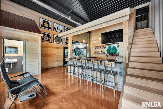 12804 W Dell Rd, Princeville, IL 61559 - indoor bar with wooden walls, finished concrete floors, and stairway