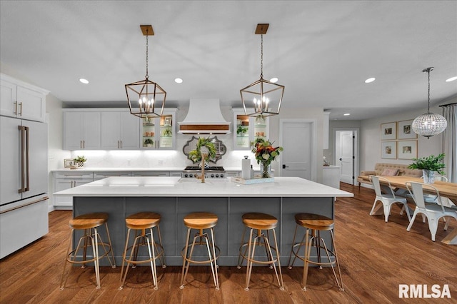 12804 W Dell Rd, Princeville, IL 61559 - kitchen featuring high end white refrigerator, premium range hood, white cabinets, recessed lighting, and a chandelier