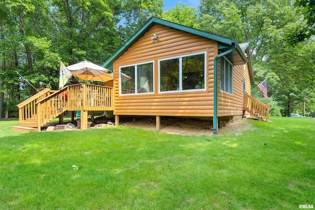 175 Lakecrest Pl, Dahinda, IL 61488 - rear view of house featuring stairs, log veneer siding, a wooden deck, and a lawn