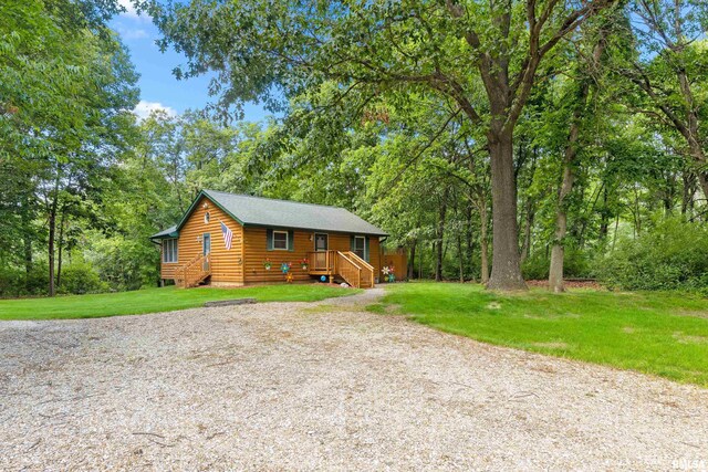 175 Lakecrest Pl, Dahinda, IL 61488 - chalet / cabin with log veneer siding, gravel driveway, and a front yard