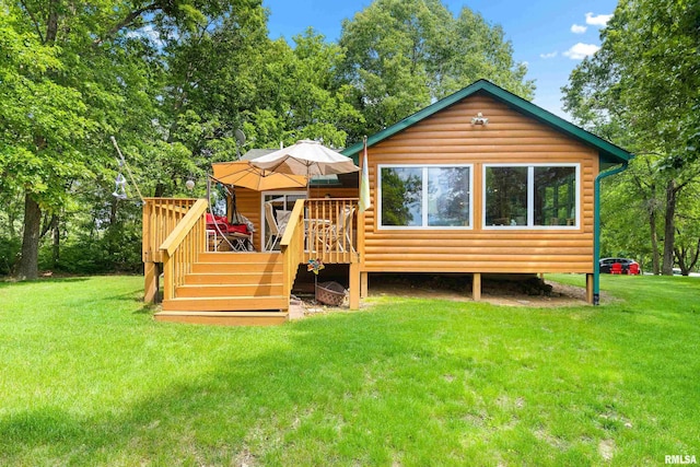 175 Lakecrest Pl, Dahinda, IL 61488 - back of house with log veneer siding, a deck, and a lawn