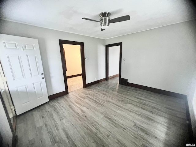 407 E Depot St, Knoxville, IL 61448 - unfurnished bedroom featuring wood finished floors and a ceiling fan