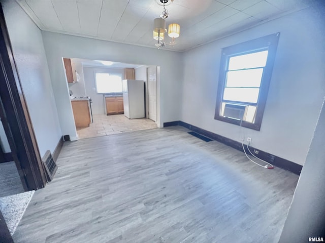 407 E Depot St, Knoxville, IL 61448 - unfurnished living room featuring light wood-style flooring and a chandelier