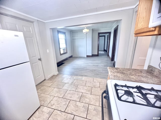 407 E Depot St, Knoxville, IL 61448 - kitchen featuring freestanding refrigerator, ornamental molding, and range with gas cooktop