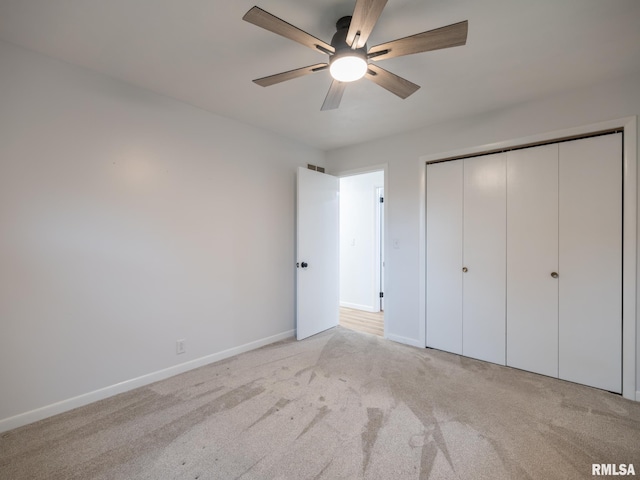 410 Stout Dr, Mackinaw, IL 61755 - unfurnished bedroom featuring light colored carpet, a closet, and a ceiling fan