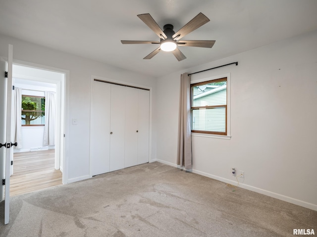 410 Stout Dr, Mackinaw, IL 61755 - unfurnished bedroom with multiple windows, carpet floors, and a closet