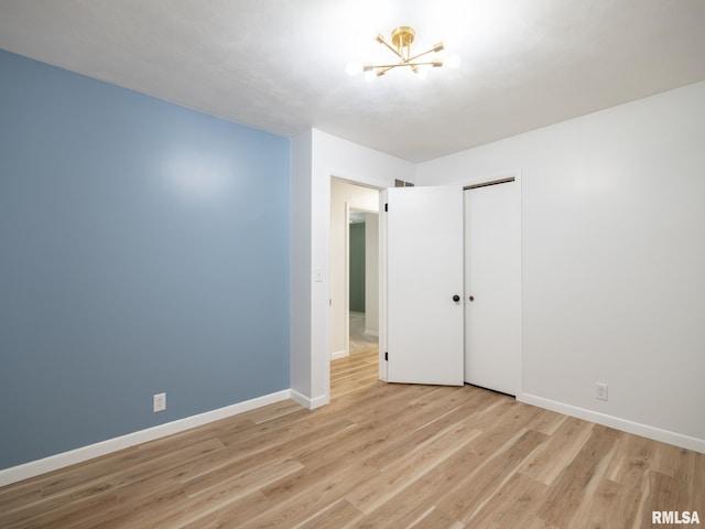 410 Stout Dr, Mackinaw, IL 61755 - unfurnished room featuring a chandelier and light wood-style floors
