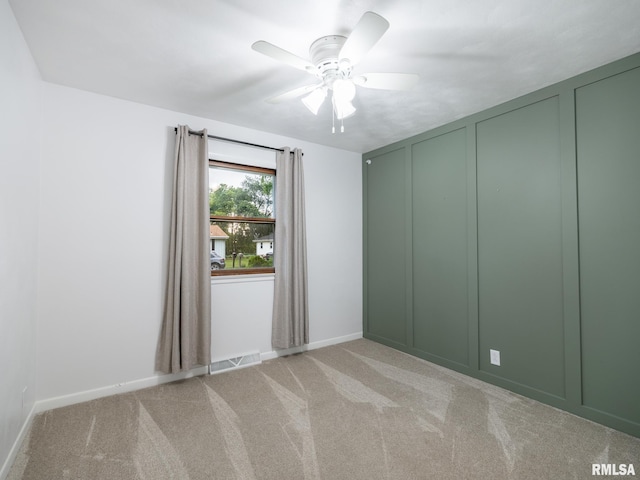410 Stout Dr, Mackinaw, IL 61755 - empty room with ceiling fan, light carpet, and a decorative wall