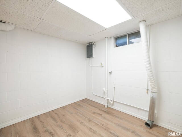 410 Stout Dr, Mackinaw, IL 61755 - finished below grade area featuring a paneled ceiling, concrete block wall, light wood-style floors, and electric panel