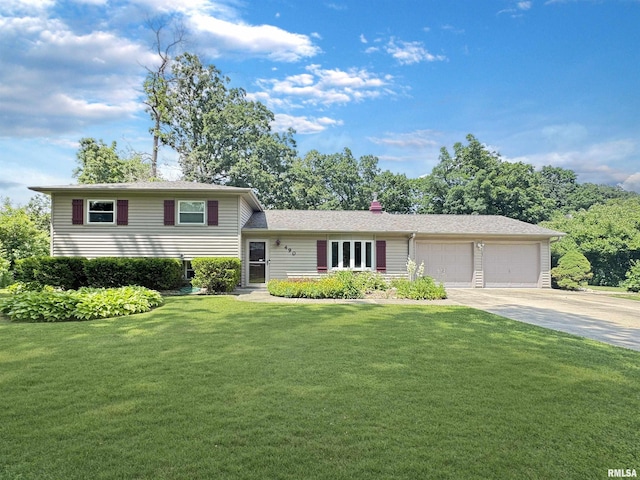 490 Oak Point Rd, Metamora, IL 61548 - tri-level home with an attached garage, concrete driveway, a front lawn, and a chimney