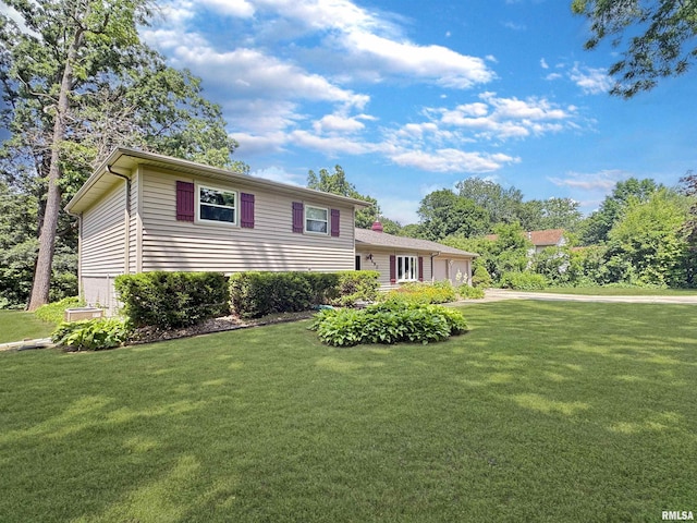 490 Oak Point Rd, Metamora, IL 61548 - split level home featuring an attached garage, a front yard, and concrete driveway