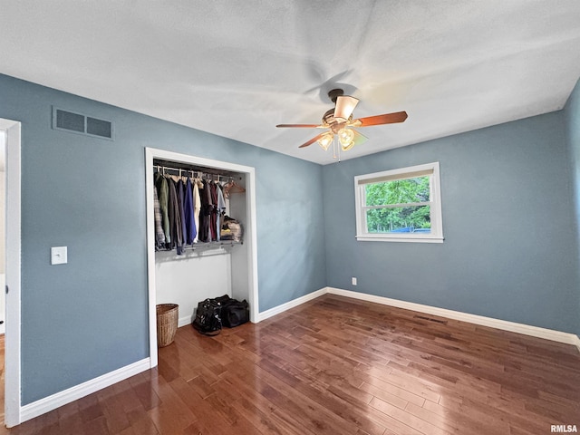490 Oak Point Rd, Metamora, IL 61548 - unfurnished bedroom featuring wood finished floors, a closet, and ceiling fan