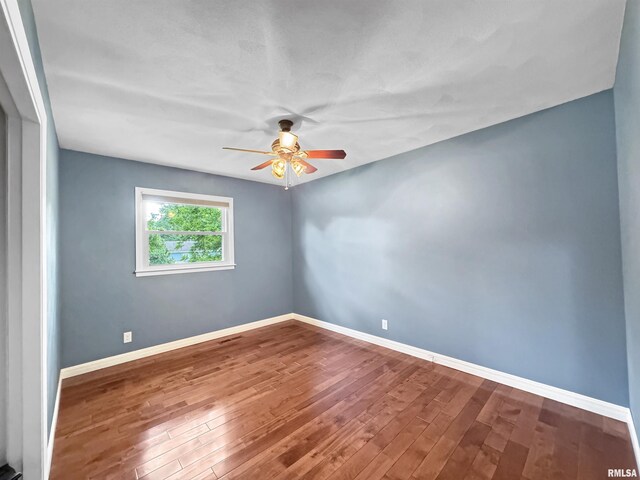 490 Oak Point Rd, Metamora, IL 61548 - empty room with a ceiling fan and wood finished floors