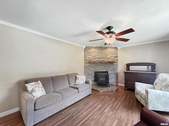 490 Oak Point Rd, Metamora, IL 61548 - living area with a wood stove, a ceiling fan, wood finished floors, and crown molding