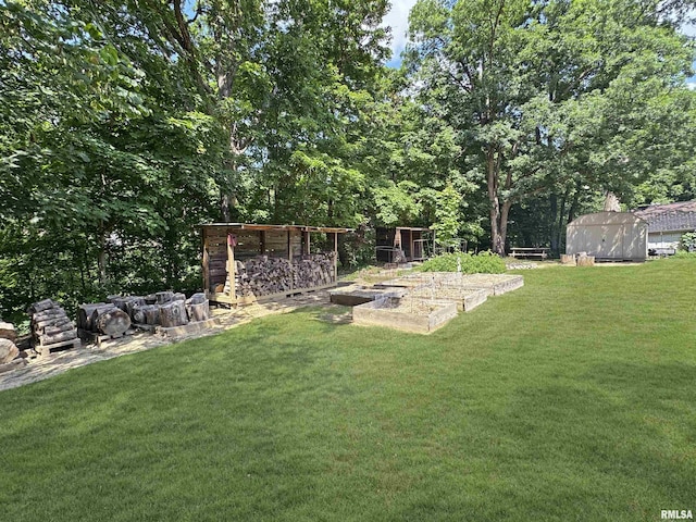 490 Oak Point Rd, Metamora, IL 61548 - view of green lawn with a vegetable garden and a shed
