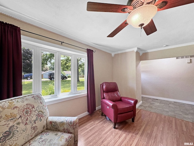 490 Oak Point Rd, Metamora, IL 61548 - living area with plenty of natural light, crown molding, ceiling fan, and wood finished floors