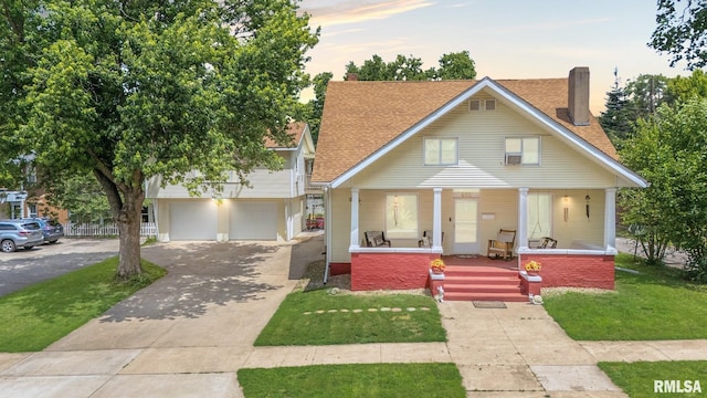 405 Washington St, Pekin, IL 61554 - view of front of property featuring covered porch, concrete driveway, a chimney, a front lawn, and roof with shingles