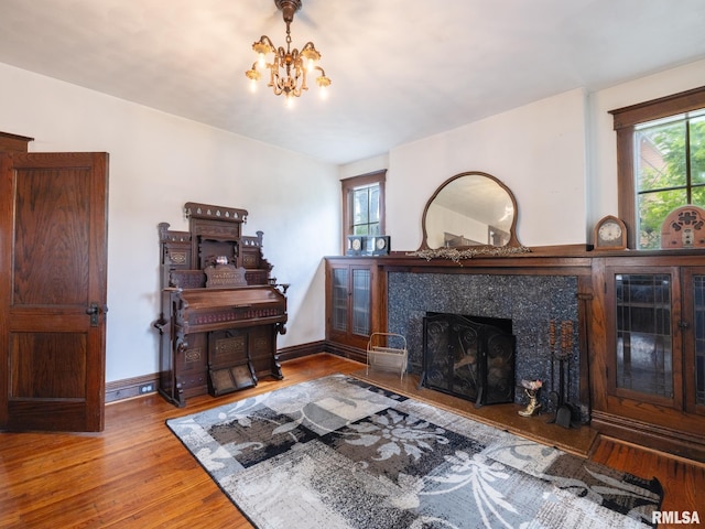 405 Washington St, Pekin, IL 61554 - living room featuring wood finished floors, a chandelier, and a fireplace