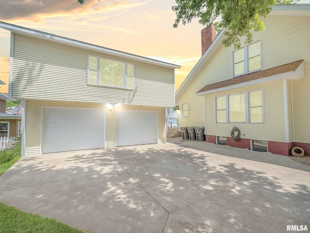 405 Washington St, Pekin, IL 61554 - view of front of property with a chimney, concrete driveway, and an attached garage