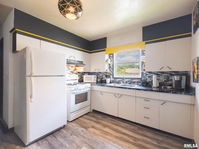 405 Washington St, Pekin, IL 61554 - kitchen featuring white appliances, under cabinet range hood, backsplash, and wood finished floors