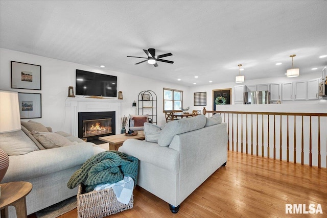 1208 S Adams Rd, Eureka, IL 61530 - living area with ceiling fan, light wood finished floors, recessed lighting, and a glass covered fireplace