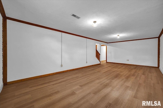 1208 S Adams Rd, Eureka, IL 61530 - spare room with crown molding, wood finished floors, and a textured ceiling