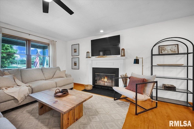 1208 S Adams Rd, Eureka, IL 61530 - living area with ceiling fan, a fireplace with flush hearth, wood finished floors, a textured ceiling, and recessed lighting
