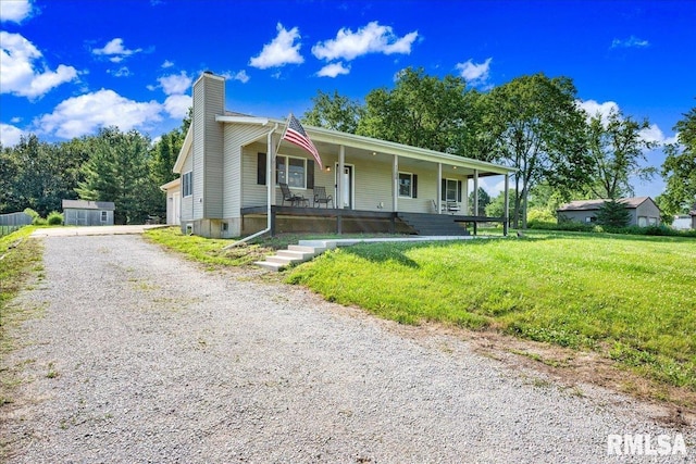 1208 S Adams Rd, Eureka, IL 61530 - view of front facade with covered porch, a chimney, a front lawn, and gravel driveway