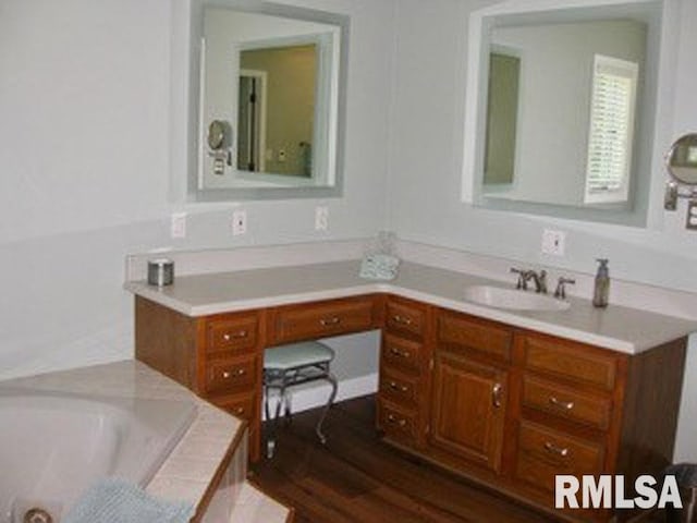 17215 N Mangold Rd, Edelstein, IL 61526 - full bath with vanity, a whirlpool tub, and wood finished floors