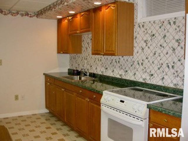 17215 N Mangold Rd, Edelstein, IL 61526 - kitchen featuring white electric range oven, dark countertops, decorative backsplash, and brown cabinets