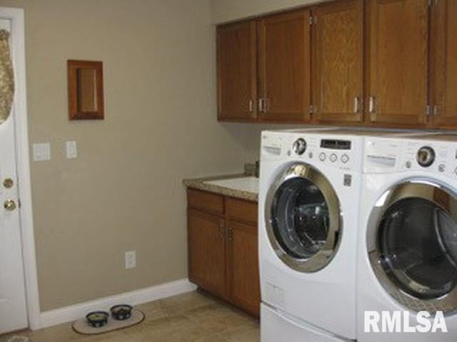 17215 N Mangold Rd, Edelstein, IL 61526 - laundry area with washer and dryer, cabinet space, and light tile patterned flooring