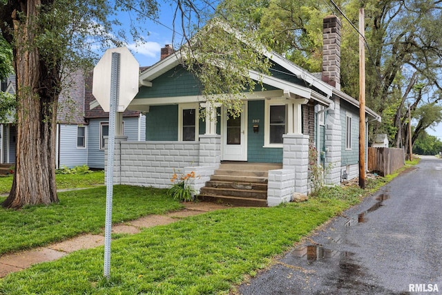 2017 W Laura Ave, West Peoria, IL 61604 - view of front of home with a chimney and covered porch