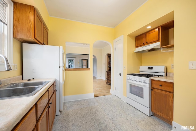 2017 W Laura Ave, West Peoria, IL 61604 - kitchen with white appliances, under cabinet range hood, brown cabinets, and light countertops