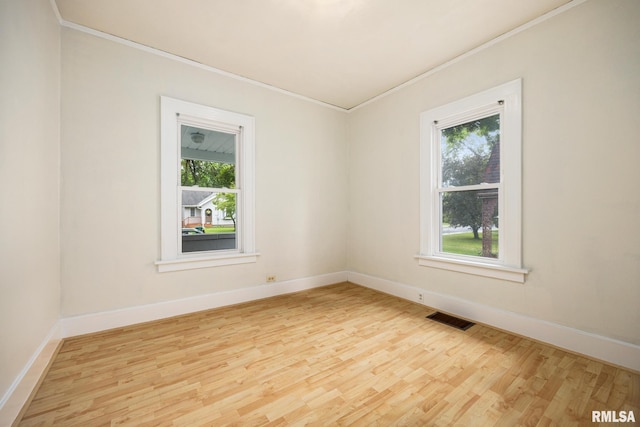2017 W Laura Ave, West Peoria, IL 61604 - unfurnished room with crown molding, light wood-type flooring, and plenty of natural light