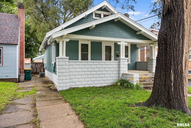 2017 W Laura Ave, West Peoria, IL 61604 - view of front of house featuring covered porch and a chimney
