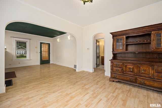 2017 W Laura Ave, West Peoria, IL 61604 - unfurnished room with arched walkways, ornamental molding, and light wood-style flooring