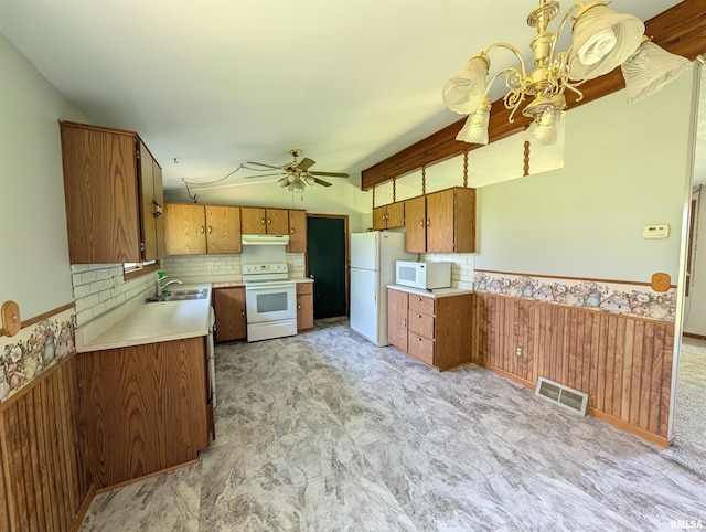 6646 Mason Rd, Manito, IL 61546 - kitchen featuring white appliances, brown cabinetry, under cabinet range hood, lofted ceiling, and a ceiling fan