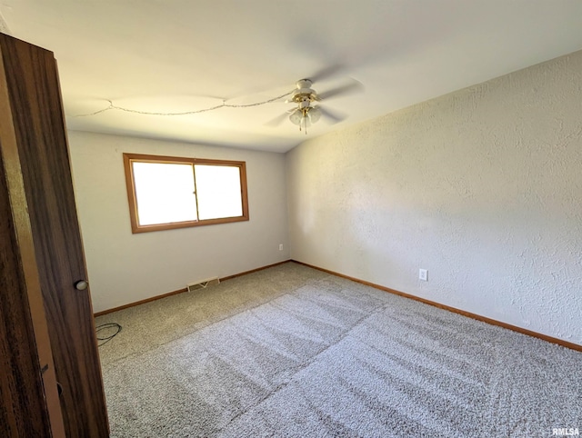 6646 Mason Rd, Manito, IL 61546 - unfurnished room with ceiling fan, carpet floors, and a textured wall