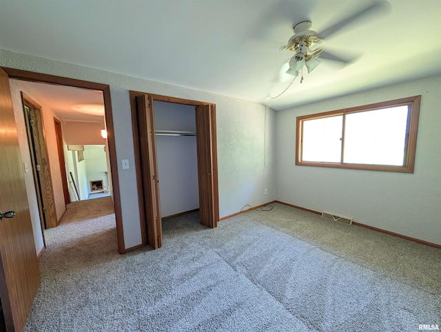 6646 Mason Rd, Manito, IL 61546 - unfurnished bedroom with light colored carpet, a closet, and a ceiling fan
