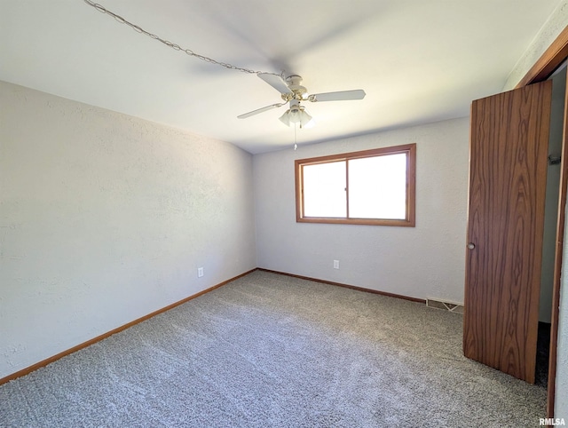 6646 Mason Rd, Manito, IL 61546 - unfurnished bedroom with carpet, a ceiling fan, and a textured wall