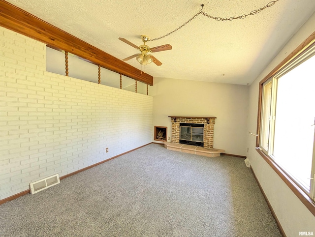 6646 Mason Rd, Manito, IL 61546 - unfurnished living room featuring brick wall, a ceiling fan, a textured ceiling, a brick fireplace, and carpet