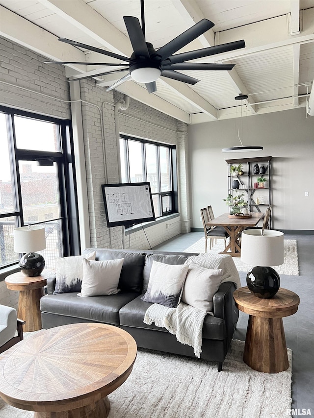 1001 SW Adams St Unit 101, Peoria, IL 61602 - living room with a ceiling fan, beamed ceiling, finished concrete floors, and brick wall