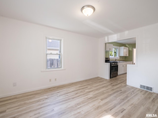 1108 Mechanic St, Pekin, IL 61554 - unfurnished living room featuring light wood-style flooring and a sink